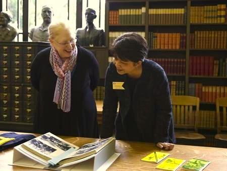 two people review Oregon historical documents in University Archives